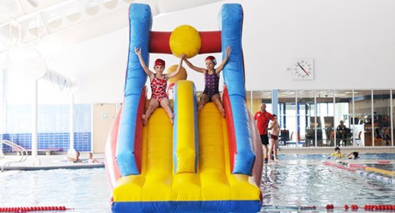 Children on an inflatable in the pool